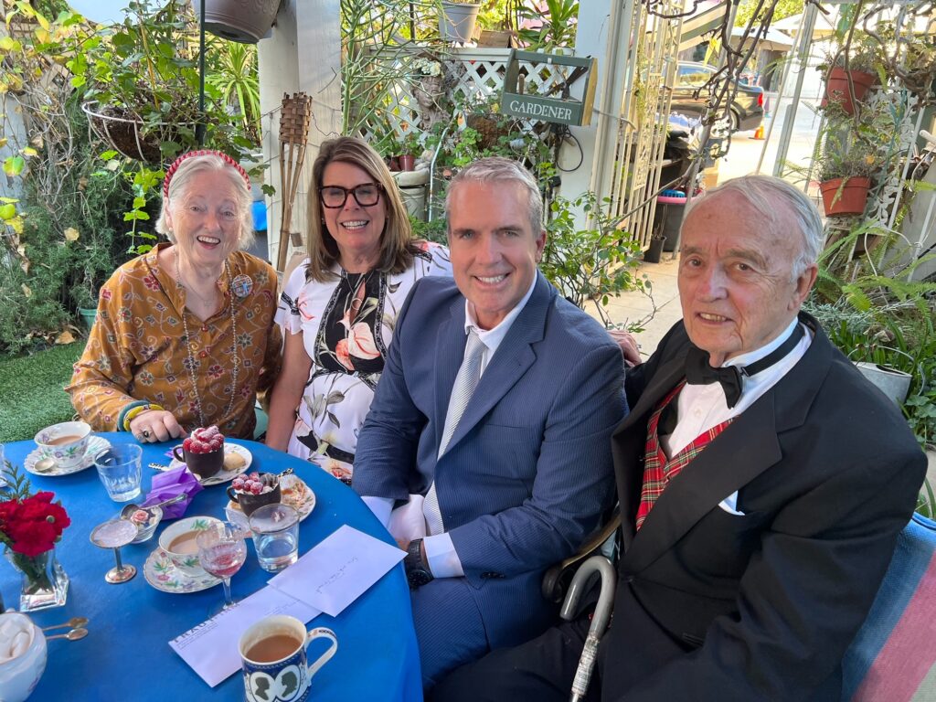 Members of the Bloom 90 Club sitting with Eric Traut around a table.